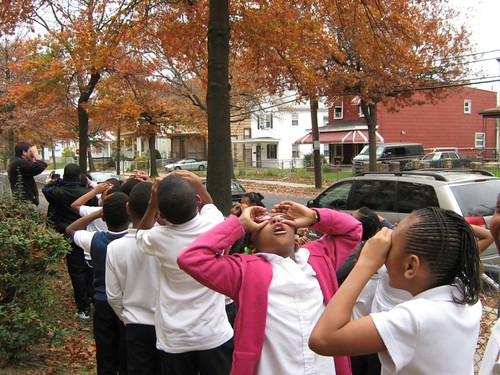 Students from the Paul Public Charter School in Washington, D.C., take to the streets pretending to use binoculars in search of their urban forest with a member of the Missoula (Montana) Chlidren's Theatre. The Missoula Children's Theatre works with the U.S. Forest Service to develop interactive, engaging performing arts school assemblies and workshops.
