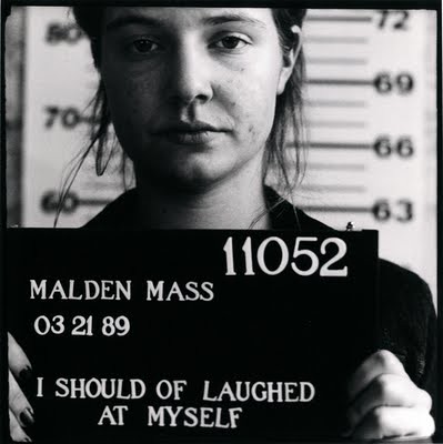 Black and white mugshot-style photo of a young white woman. Text reads I should of laughed at myself