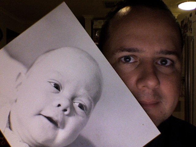 Take a photo of someone holding a photograph of themselves - Baby me & Current me