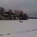 Snowmobile pulling an ice fishing hut