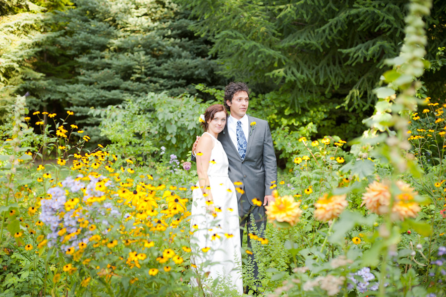 Married couple standing in a field of wildflowers at Mt. Hood Organic Farms