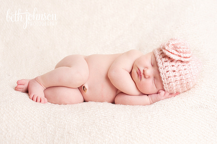 tallahassee baby girl in pink hat on cream blanket newborn photography