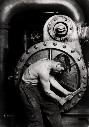 Mechanic at steam pump in Electric power house., 1920