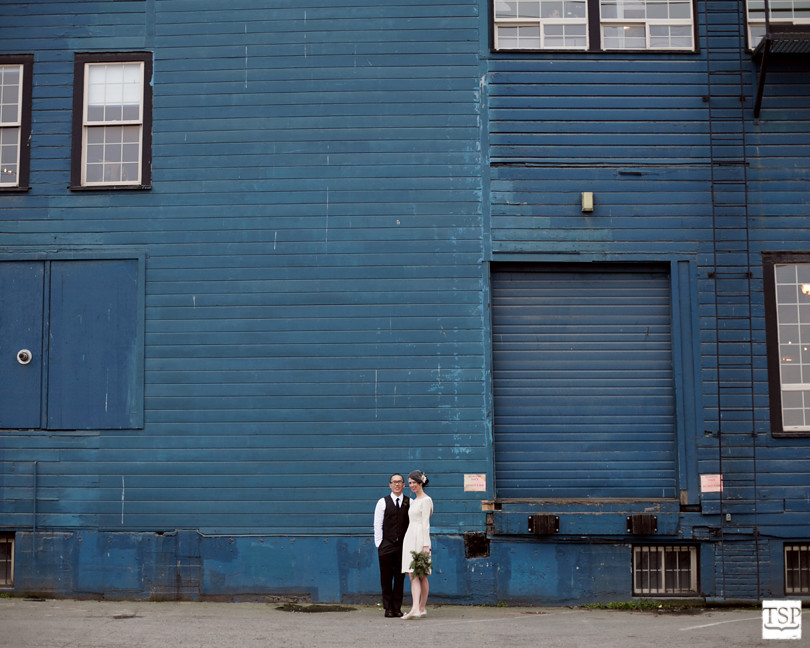 Bride and Groom in front of Blue Building