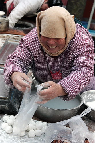 Lady bagging dumplings to be cooked at home