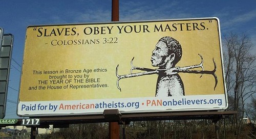 billboard depicting an illustration of a shackled black man. Text reads: Slaves, obey your masters. This lesson in the Bronze Age brought to you by the year of the bible and the house of representatives.