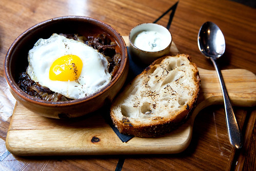 Braised short ribs beef hash with sunny side egg and grilled country bread