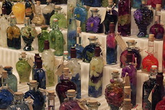 silk flowers inside bottles with oil as oil lamps