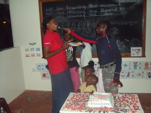 saidi feeds Auntie Mapenzi the cake