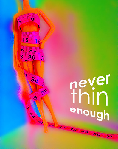 Never Thin Enough: a Model Muse body Barbie wrapped in hot pink measuring tape