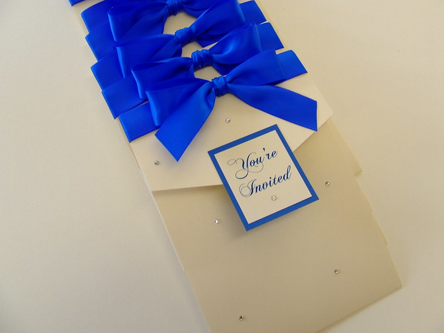 Pearlised cream 5x7 portrait pocketfold with electric blue ribbon and lots