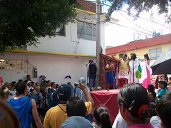 The group observes the re-enactment of Jesus' trial and crucifixion