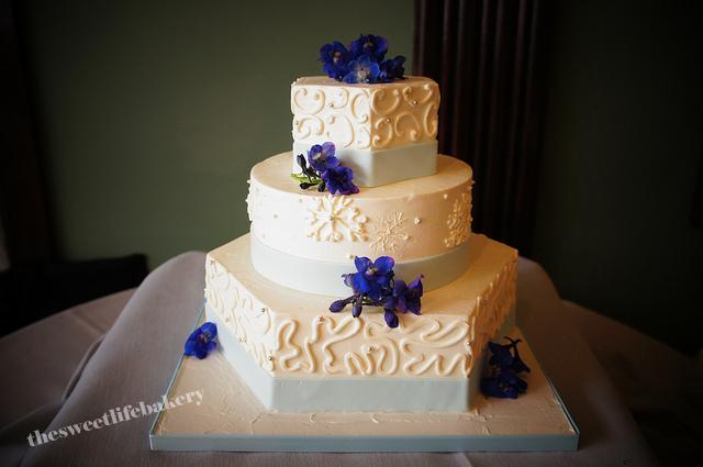 This late winter wedding cake had snowflakes carved and piped onto the