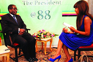 Republic of Zimbabwe President Robert Mugabe with Deputy Editor of the Sunday Mail Nomsa Nkala on the eve of his 88th birthday. Zimbabwe has fought western sanctions for over two decades. by Pan-African News Wire File Photos
