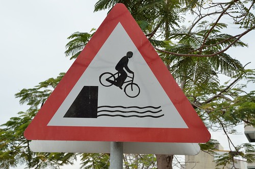 Warning: bicycle falling in water.