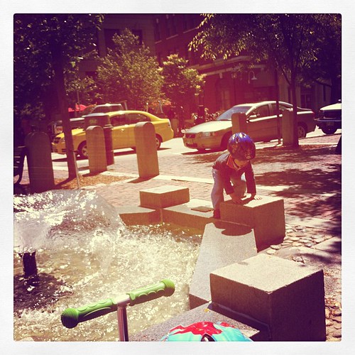Playing at the water fountain