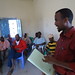 Odweyne staff team leader, Abdirahman, updating the village project implementation committee on projects status.
