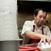 Timmy Chan packing an order at Yum Yum, Fields Corner, Dorchester posted by Planet Takeout to Flickr
