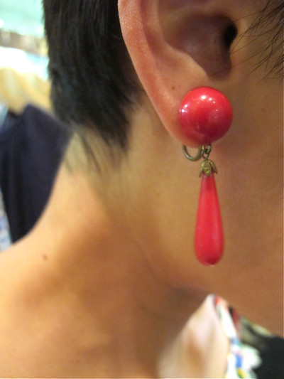 Red plastic screw-back dangling earrings
