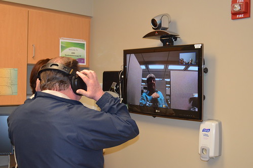 USDA Rural Utilities Service General Field Representative Wayne Ahlgren  tests the telemedicine equipment on a recent tour of Avera Health in Sioux Falls, South Dakota with Loren Eitreim, Video Technician at Avera shown on the monitor. 