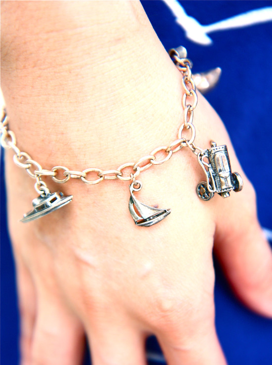 Vintage silver charm bracelet with boat and automobile charms.