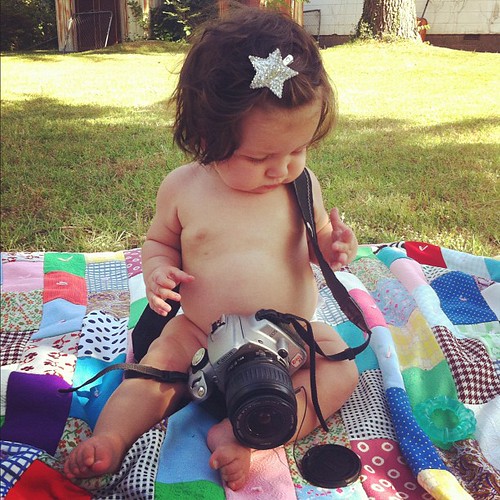 Starting her young. Letting her play with our old camera.