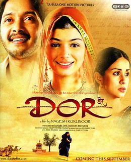 The poster for Dor. It is bright, with the face a smiling woman with a beautiful veil in the center. In the upper left corner is a man's face, looking away from the camera but optimistic. In the bottom right is another woman's face. She is not wearing a veil and has a troubled expression.
