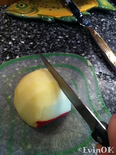 Slicing a peeled apple