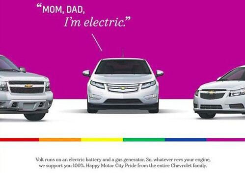 A Chevy volt advertisement that has three cars. The car in the middle says 'Mom, dad? I'm electric.' There is a rainbow stripe across the bottom of the ad.