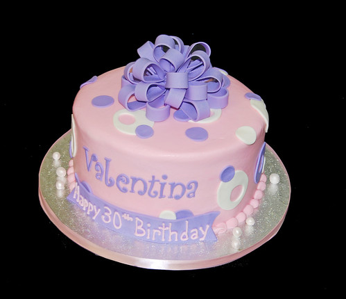 pink and purple sassy circles cake topped with a purple bow for a 30th birthday