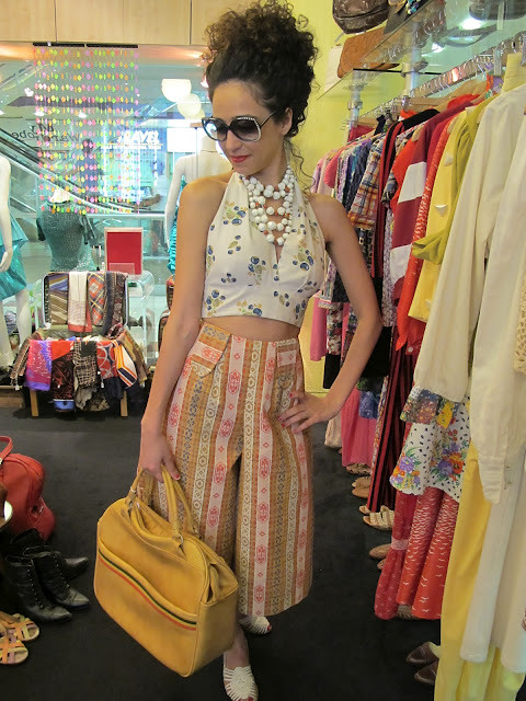  1950s beads, 1980s Hilite sunglasses and 1970s printed halter top, 1970s bermudas and vintage travel bag from Granny's Day Out.