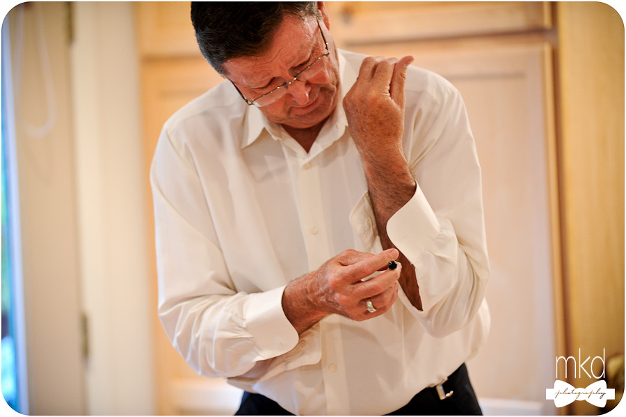 Father of the bride putting on cufflinks
