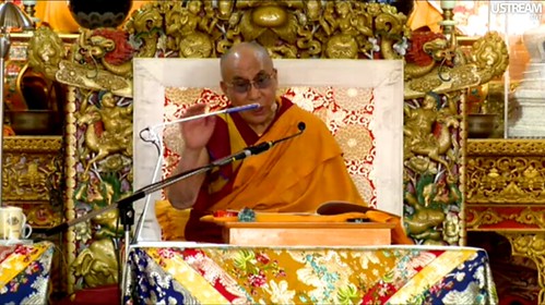 His Holiness the Great 14th Dalai Lama gesturing, teaching live over the Internet Introductory Buddhist Teachings, Tibetan Buddhist monk, ornate symbolic throne, Main Tibetan Temple in Dharamsala, India by Wonderlane