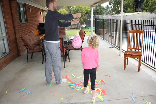 Maisie checking if daddy holding the pinata was the best system