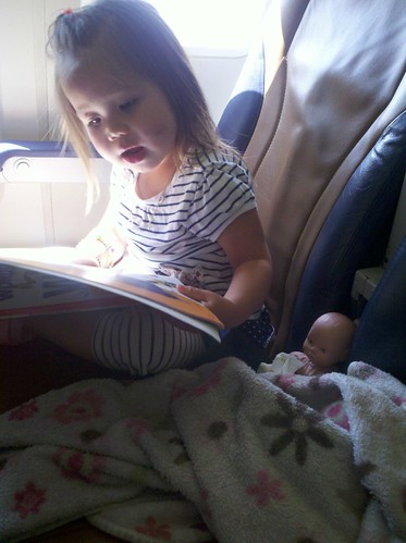 Reading to baby on the plane.