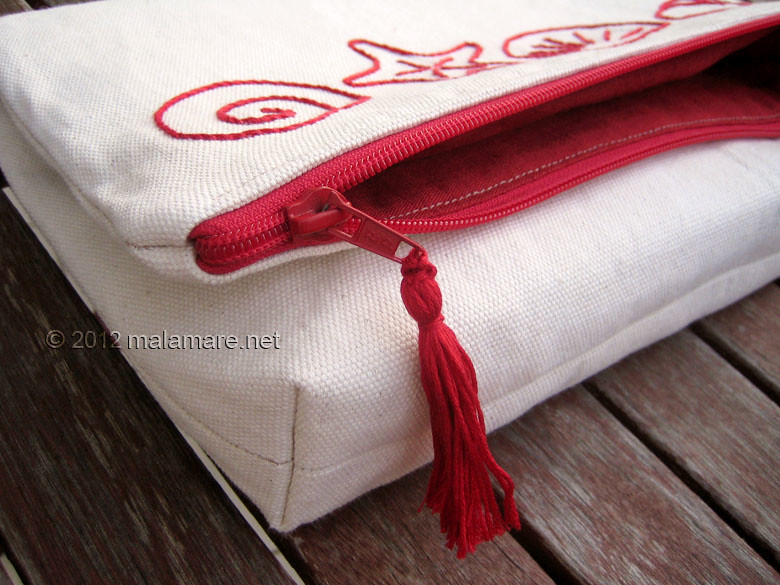 foldover cotton clutch with red hand embroidery zipper and tassel