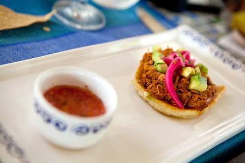Corn cake with pulled pork, pickled red onion, avocado, and a side of habanero salsa