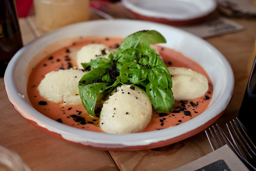 Baked ricotta on tomato coulis with dried black olive