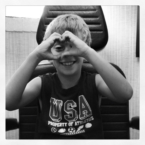 JPAD: 25: heart. Alex making a heart with his hands while waiting for the doctor. He has an ear infection.