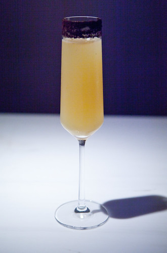 Champagne cocktail with plum wine, yuzu and rimmed with black sea salt