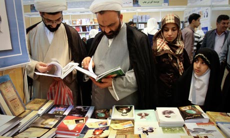 men and women browsing the selections at the book fair