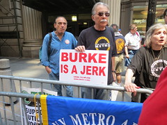 Chuck Zlatkin of the New York Metro Area Postal Union holds a sign denouncing Con Edison CEO Kevin Burke.