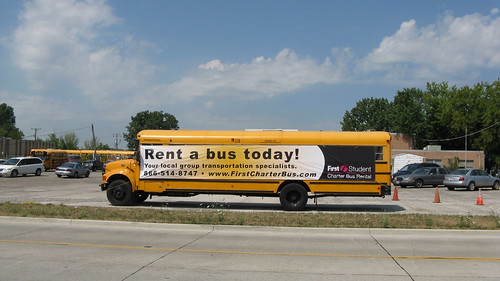First Student school bus with advertising banner attatched.  Glenview Illinois. July 2012. by Eddie from Chicago