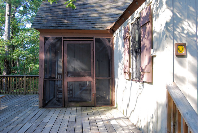 Cabin 4 small screened in porch with rockers at First Landing State Park