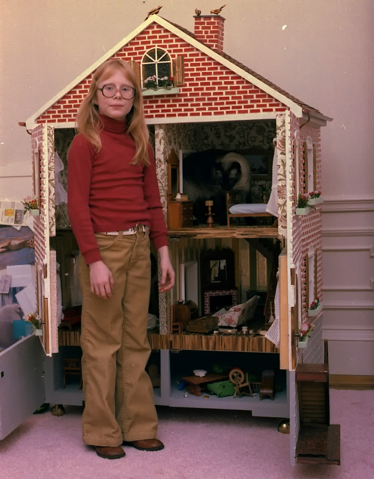 President Carter's daughter Amy poses with her dollhouse at the White House, 1978