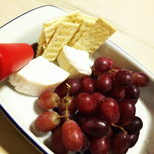 TV time! While munching on grapes, crackers and soft cheeses, paired with a glass of red wine.