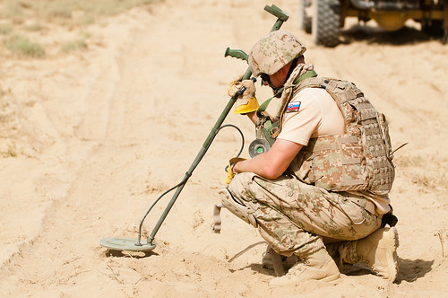 A Slovakian Army explosive ordinance disposal specialist performs a fine cleaning
