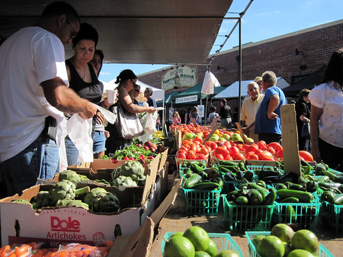 Customers scoop up a handful of the healthy, fresh produce available at one of the many farmers’ markets found in communities across America.