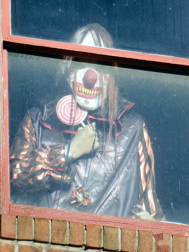 Evil Clown Looking Out of an Upstairs Window