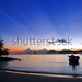 Peaceful Sunset on Exotic Bay with Boat © bluedarkat